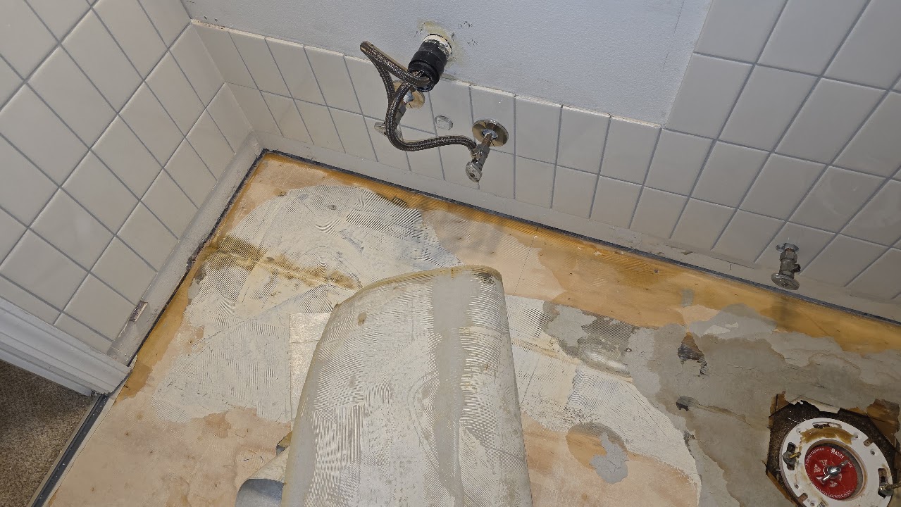 Bathroom subfloor after material removal.