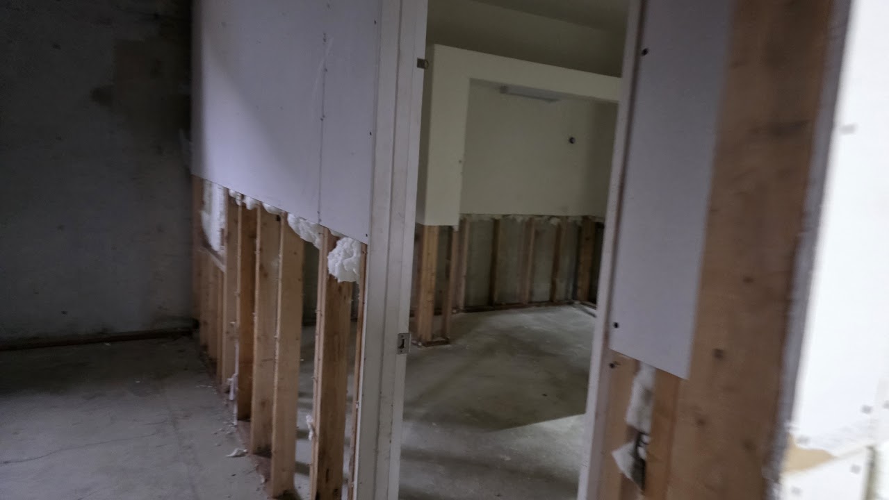 Lower wall framing exposed before repairs.